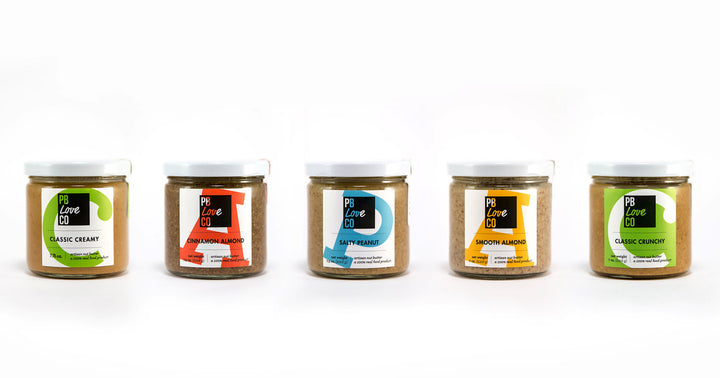 PB Love Co five full flavors jars image - Classic Creamy, Cinnamon Almond, Salty Peanut, Smooth Almond, and Classic Crunchy.